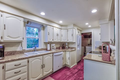 Light and bright kitchen with dishwasher, microwave, coffee maker, toaster oven