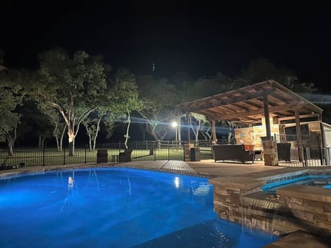 Pool, waterfall and cabana in the evening