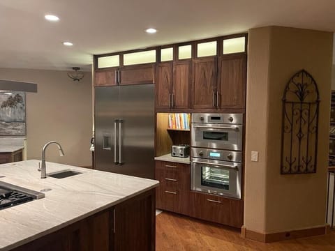 Kitchen view showing large refrigerator, microwave/speed oven & a steam oven