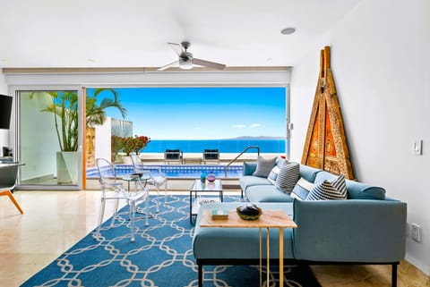Antique filled upper level living room open to terrace with panoramic ocean view
