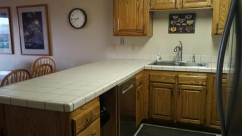 Kitchen area with a new faucet and dishwasher.