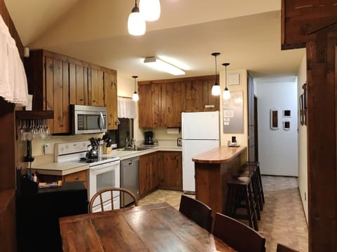 Open kitchen with adjacent counter creates a culinary and social atmosphere.