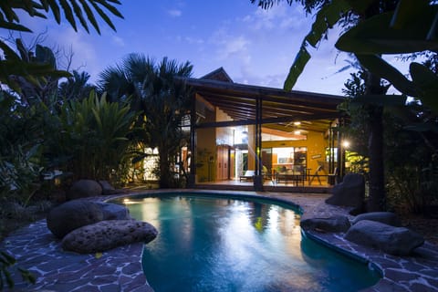 Private poolside patio with BBQ, lounge chairs and outdoor dining table.  