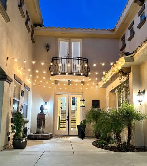Driveway entry courtyard w/ café lights; keypad French-door self check-in.