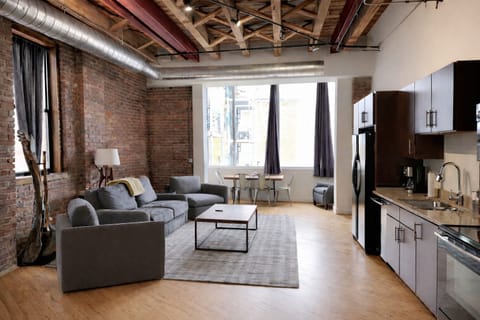 Spacious kitchen and living room area with queen sleeper sofa.