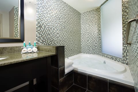 Suite, 1 King Bed, Jetted Tub | Bathroom | Combined shower/tub, hair dryer, towels