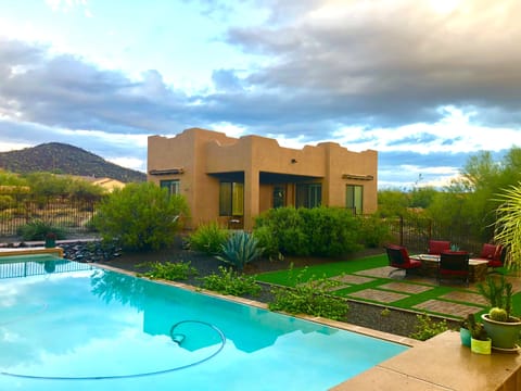 front view of casita, pool and fire pit.