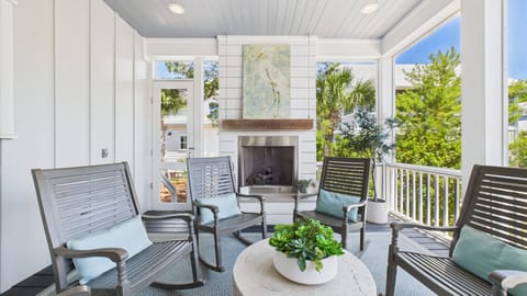 Beautiful outdoor gas fireplace- Screened rear porch with seating