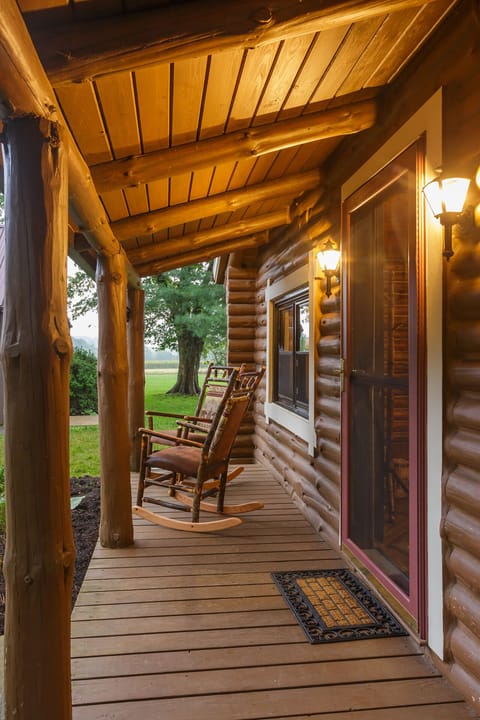 Cabin's cozy front porch with log roching chairs