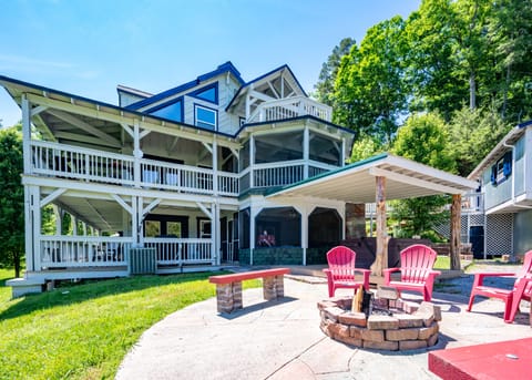 Back of property with fire pit and screened porch 