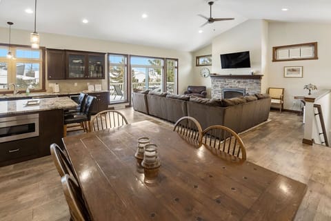 Dining area into living room, stairs down to lower level.