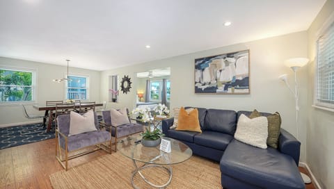Living room open to dining, kitchen, with a flat-screen TV bright and inviting!
