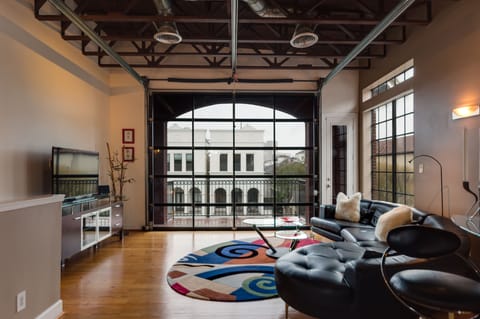 Living room with leather living room set with a huge glass door.
