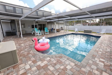 Enjoy the large heated pool, hot tub, grill, and covered patio.