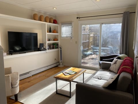 Beautiful living room connected to private backyard garden for morning coffee 