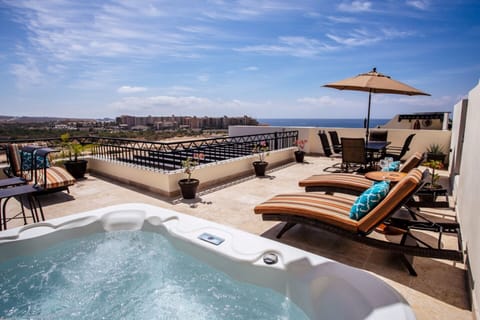 Relax in your jacuzzi on your private rooftop deck viewing the beach.