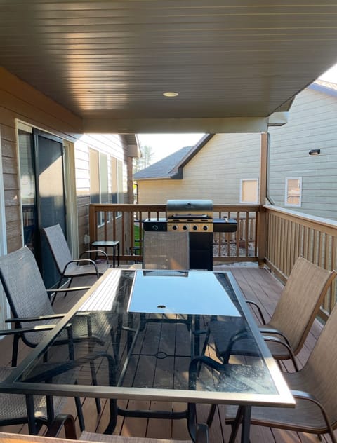 Covered deck- seating and gas grill.