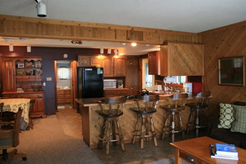 Kitchen with dining bar to right and kitchen table to left