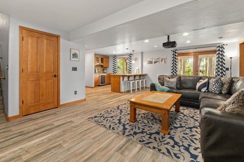 Our spacious den includes a large sectional, projector TV and kitchenette