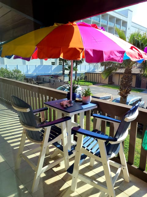 Balcony with table, chairs and rocking bench. Enjoy sunsets with a drink.