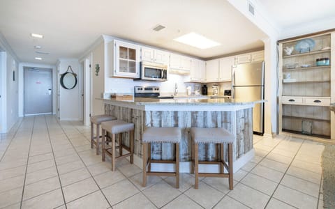 Gather around the inviting kitchen bar with seating, perfect for casual meals and conversations in a welcoming space