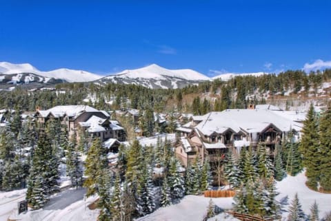 A winter wonderland, this snow-draped property harmonizes elegance and natural beauty, showcasing its architecture against a backdrop of majestic mountains.