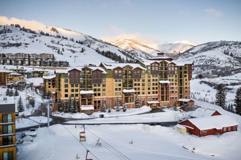 Marvel at the majestic mountains as you relax in a warm embrace, with snow blanketing the landscape around you.