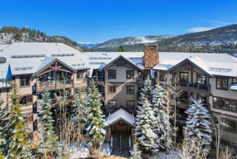 This charming community, blanketed in snow, invites exploration with its winding streets and beautiful homes nestled against the majestic mountain backdrop.