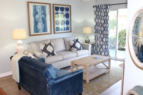 Open Concept Living Area With Doors Leading To Private Patio