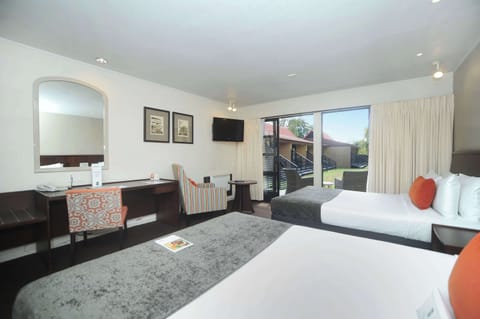 Premium bedding, desk, laptop workspace, blackout drapes