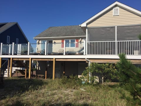 Waterfront side showing main deck, screened porch and below deck seating area