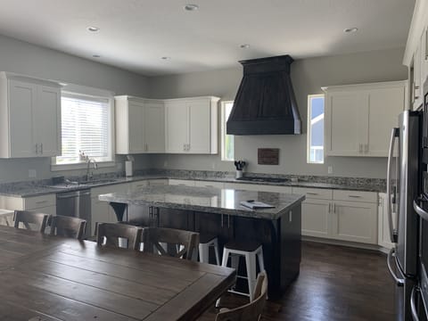 10 chairs at the table, 4 barstools & high chair + table w/4 chairs in basement 
