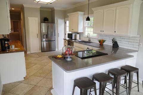 The large and well appointed kitchen is stocked w/ quality cookware and utensils