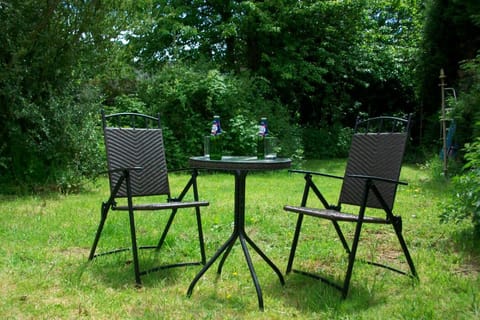Relax in the wild garden with a drink surrounded by the birds.