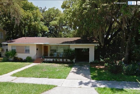 47 Fullerwood nestled in the live oaks with front porch.