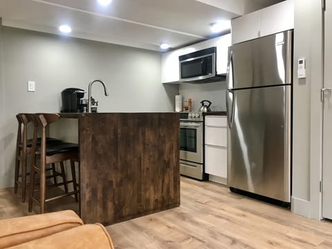 Well-equipped kitchen with ice maker, Keurig, grinder, and French press.