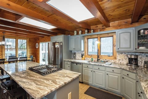 Spacious kitchen with granite counters, gas cooktop, SS appliances, and fully stocked kitchen