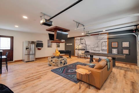 Brand new Game room with Indoor ventless Firepit, shuffleboard, foosball, 2nd fridge, and flat screen TVs to catch every game and event!