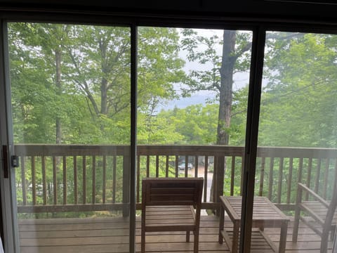 Master Bedroom - private balcony.  Summer View (partial lake views).