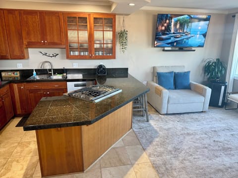 gourmet kitchen/granite island integrated downdraft perfect for entertaining.