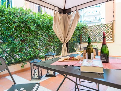 Plant, Table, Building, Window, Outdoor Table, Shade, Outdoor Furniture, Flowerpot, Flooring, Chair