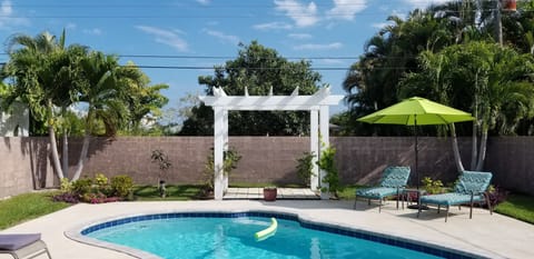 Beautiful backyard oasis with lush, tropical plants.