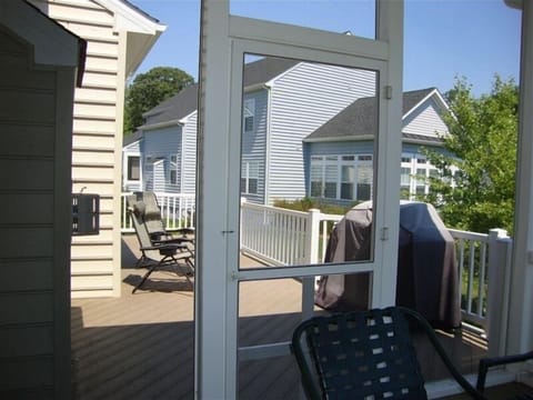 Outside deck to left and screened in porch with table and chairs