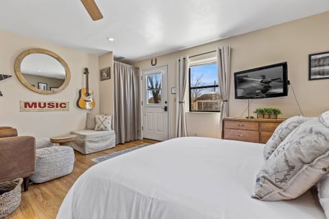 *NEW Queen bed looking on to the living area.