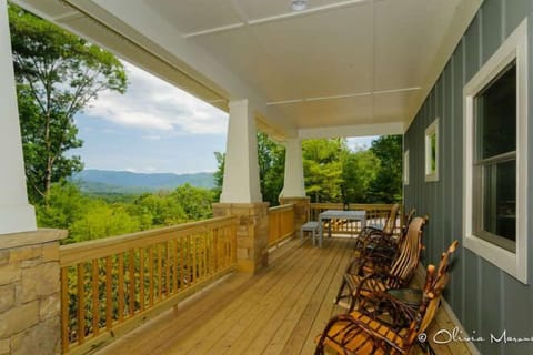 Rocking chairs on a huge covered proch with view and dining.