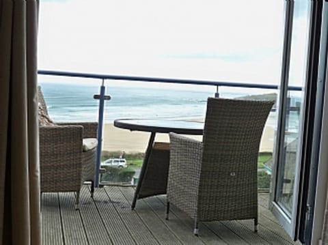 Balcony & outside table over looking beach