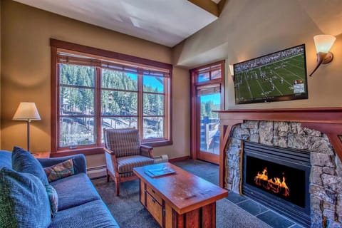 Living room with queen sofabed, door to private deck and LED HDTV.