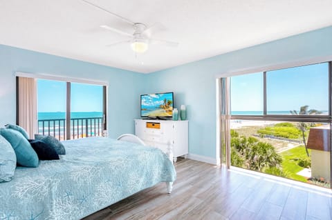 Spacious bedroom with a plush bed and floor-to-ceiling windows for views