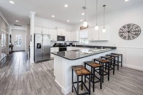 View from dining area to kitchen counter with Bar Stools.