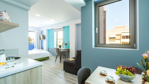 Junior Suite, Balcony | Living area | 26-inch flat-screen TV with cable channels, TV, books